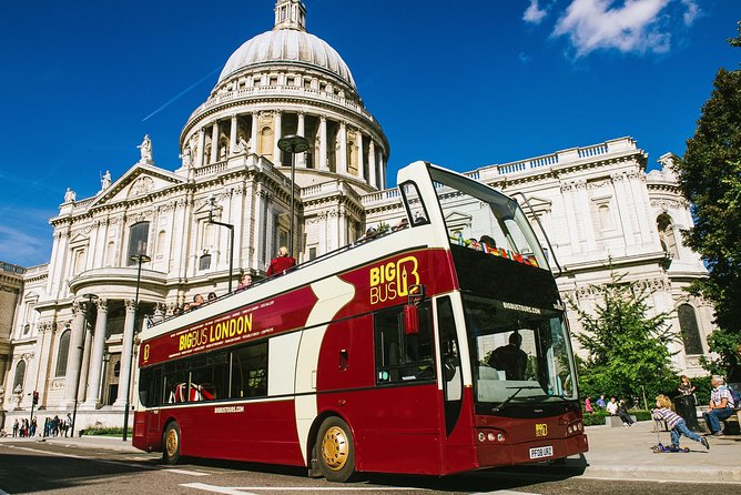 A red double-decker passing St Paul&rsquo;s Cathedral in London